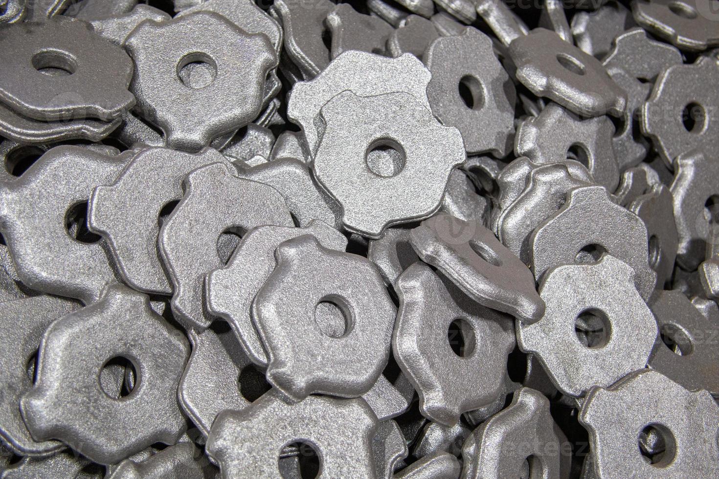 heap of gray steel forgings after shot blasting - close-up natural heavy industrial pattern with selective focus photo