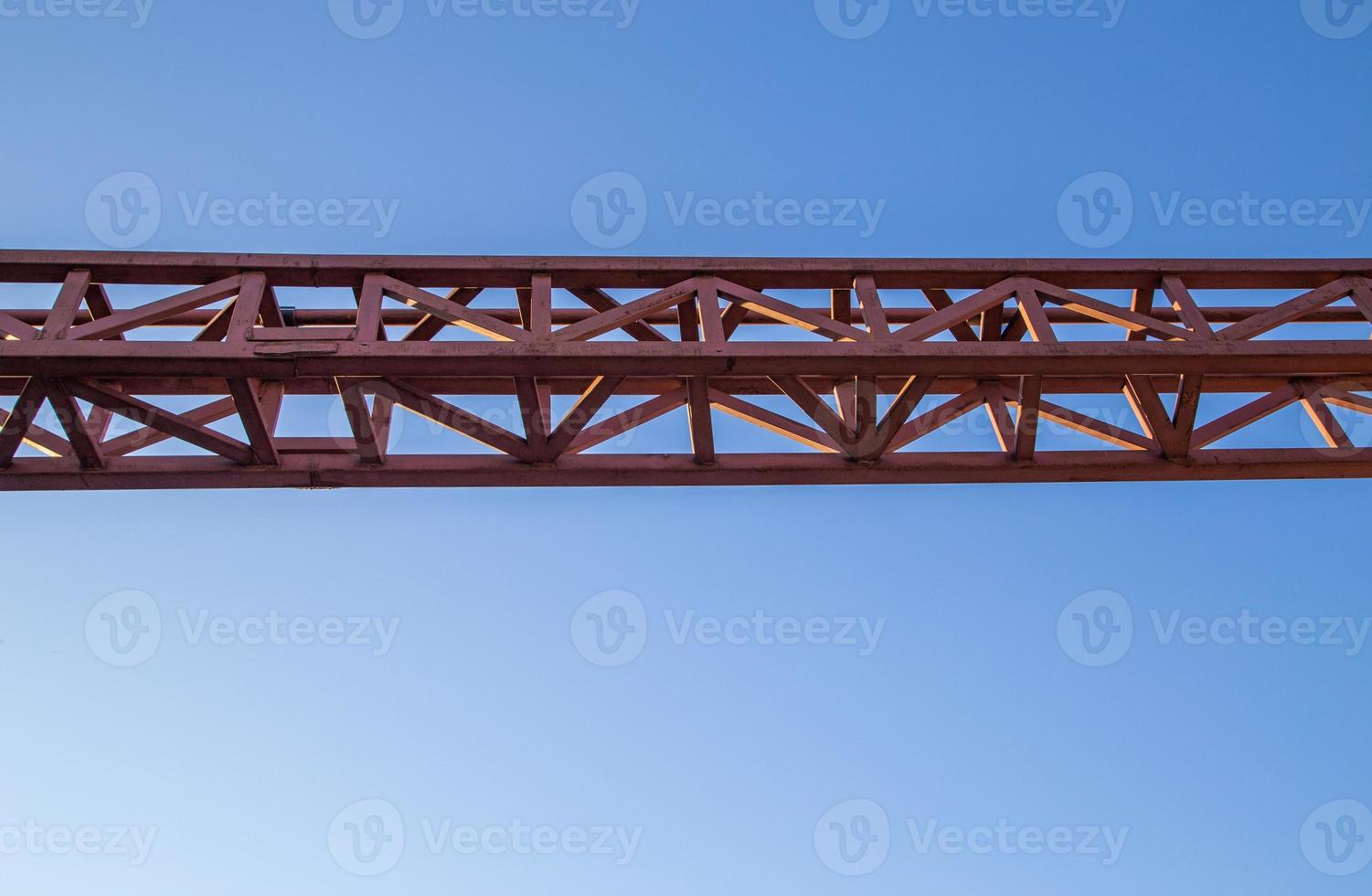 straight red steel welded truss on blue sky background photo