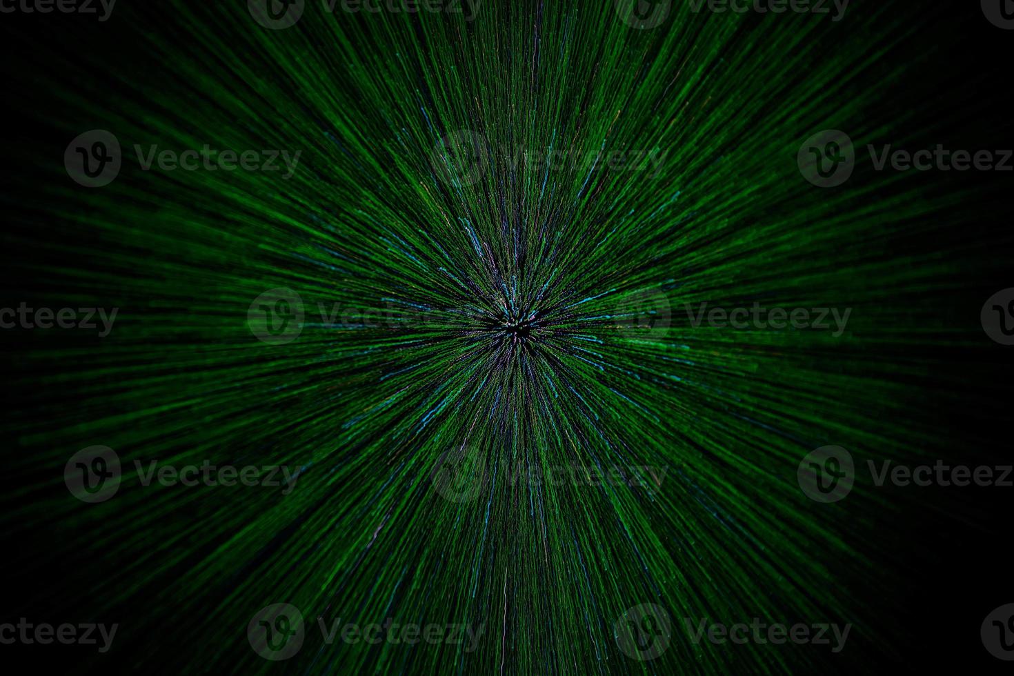 natural lens zoom explosion radial blurred green particles on black background with selective focus photo
