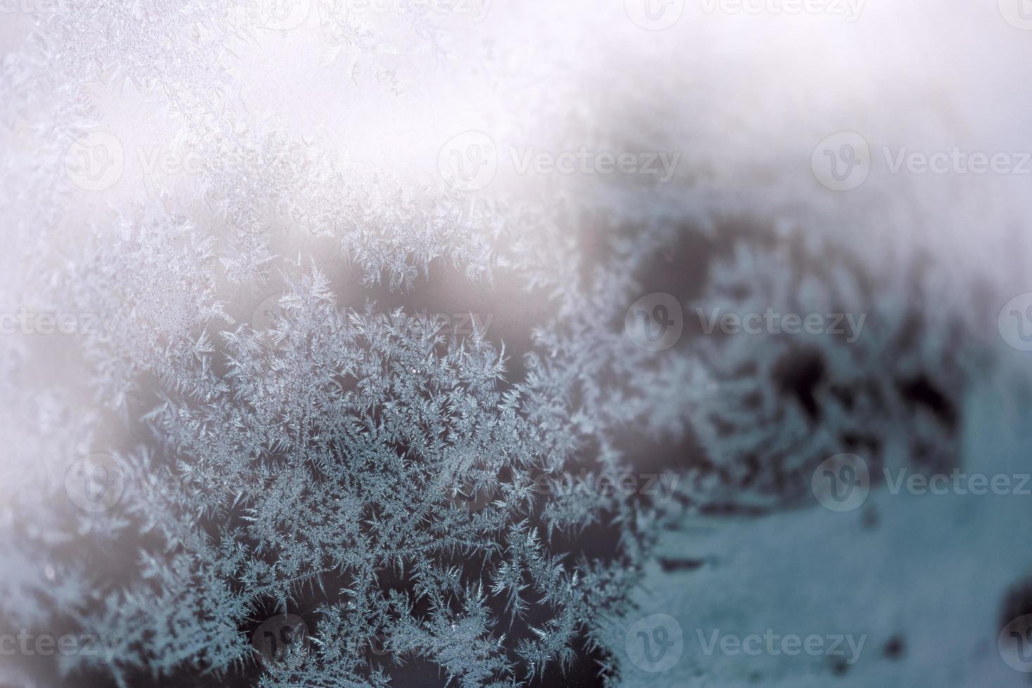 hoarfrost on window glass at daylight close-up with selective focus photo