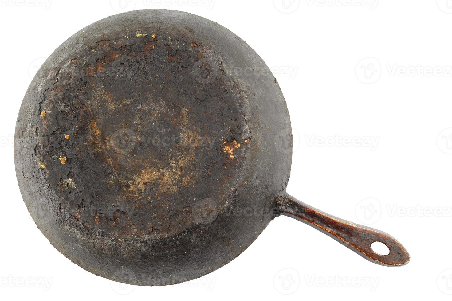 old stained rusty cast iron pan with burnt fat isolated on white bottom up in flat lay perspective photo