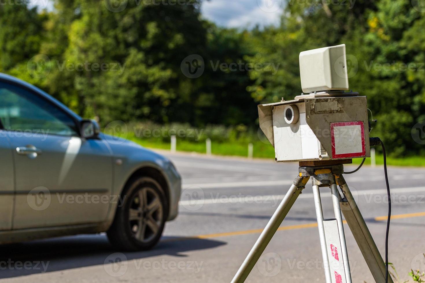 mobile speed camera device working on summer daytime road with blurry silver car in background