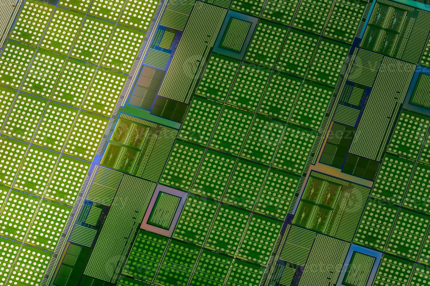 Silicon wafer with microchips used in electronics for the fabrication of integrated circuits. Full-frame high-tech macro background. photo