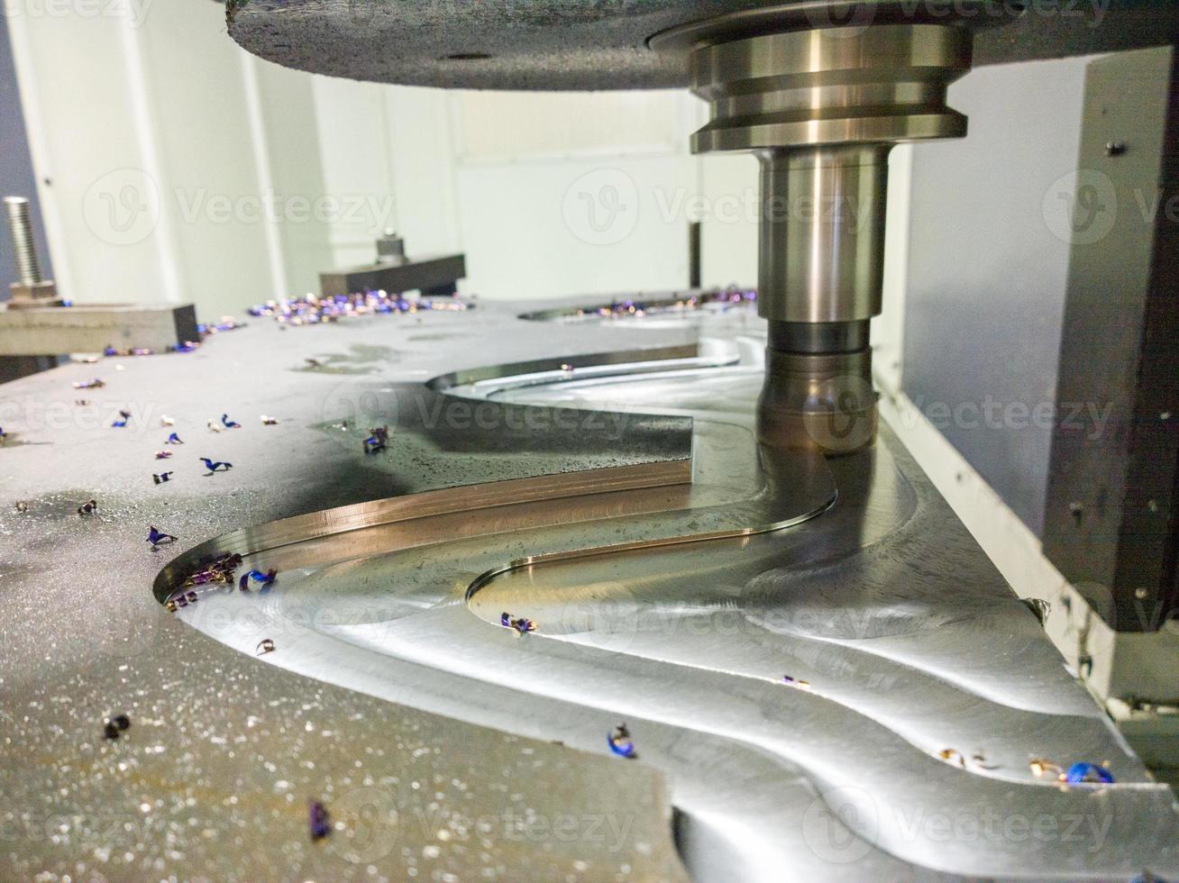 A process of cnc milling of lagre thick steel palte by curved trajectory, Selective focus with blur technique. photo