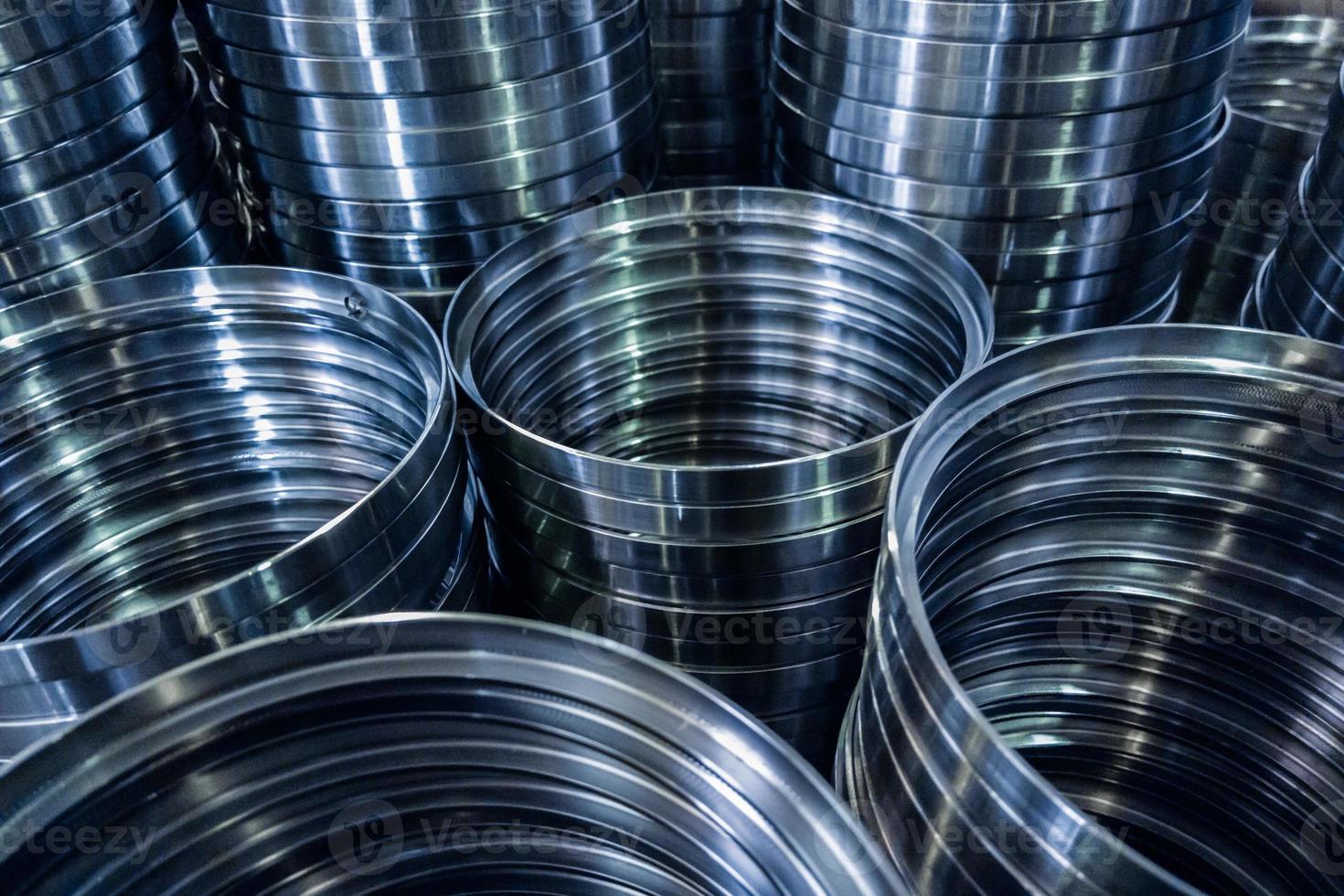 industrial manufacturing background of columns of shiny metal rings after cnc turning operation photo