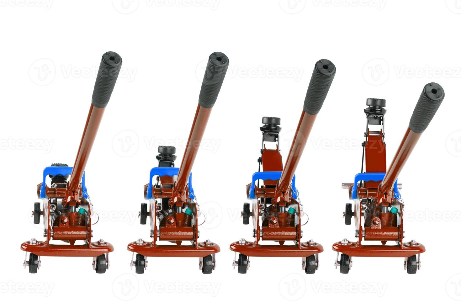 set of red isolated hydraulic car jacks on white background raised in different heights photo