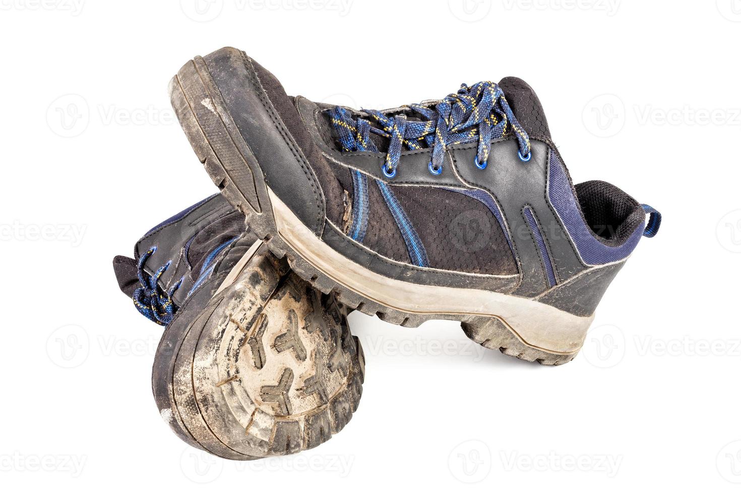 dirty used worn out black outdoor sneakers isolated on white photo