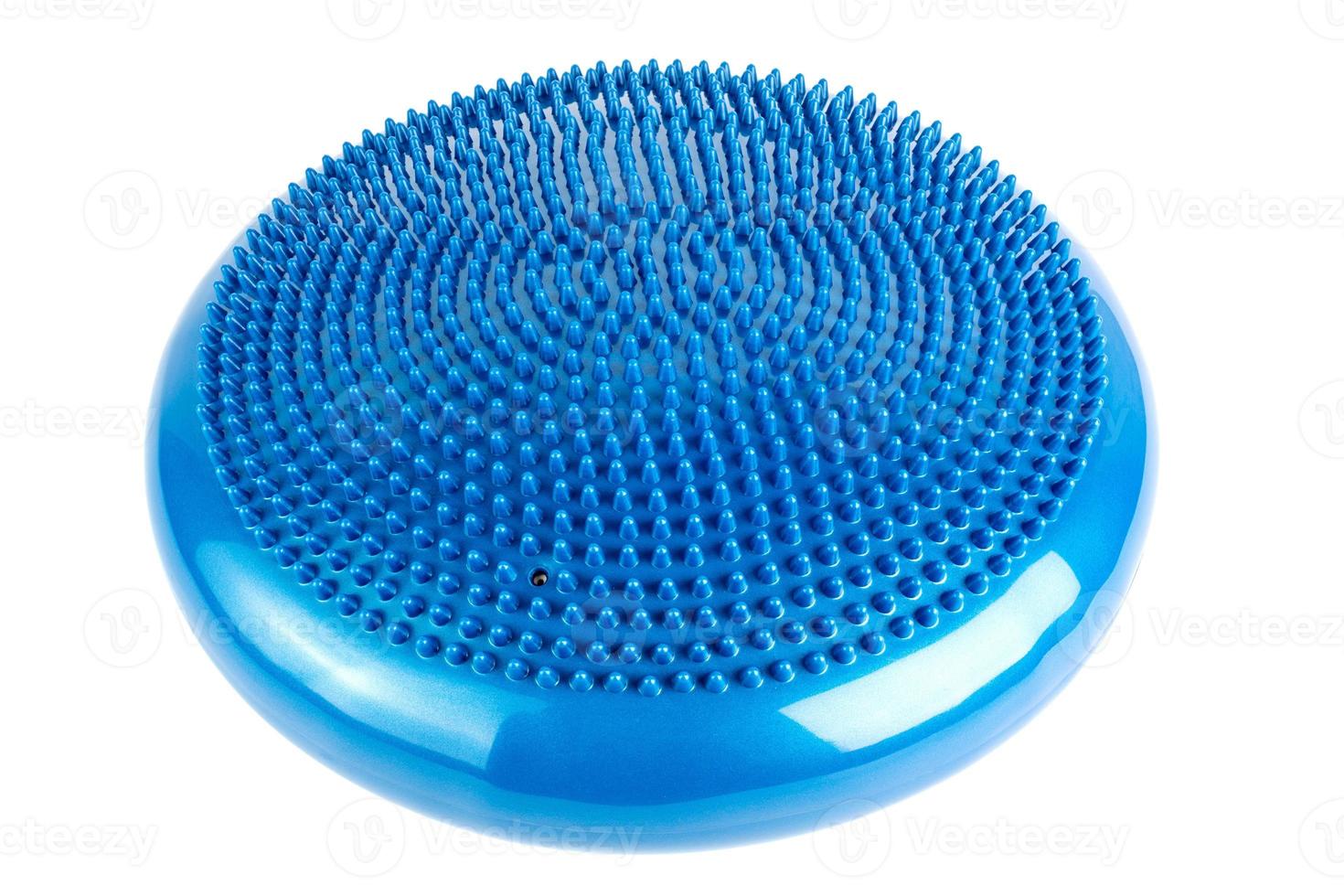 Blue inflatable balance disk isoleated on white background, It is also known as a stability disc, wobble disc, and balance cushion. photo