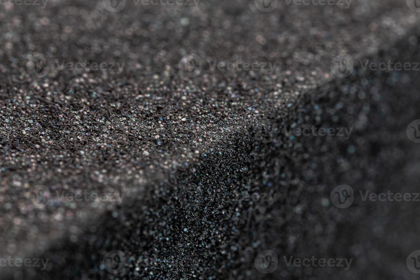 Close-up view of an edge of black rubber foam sponge brick photo
