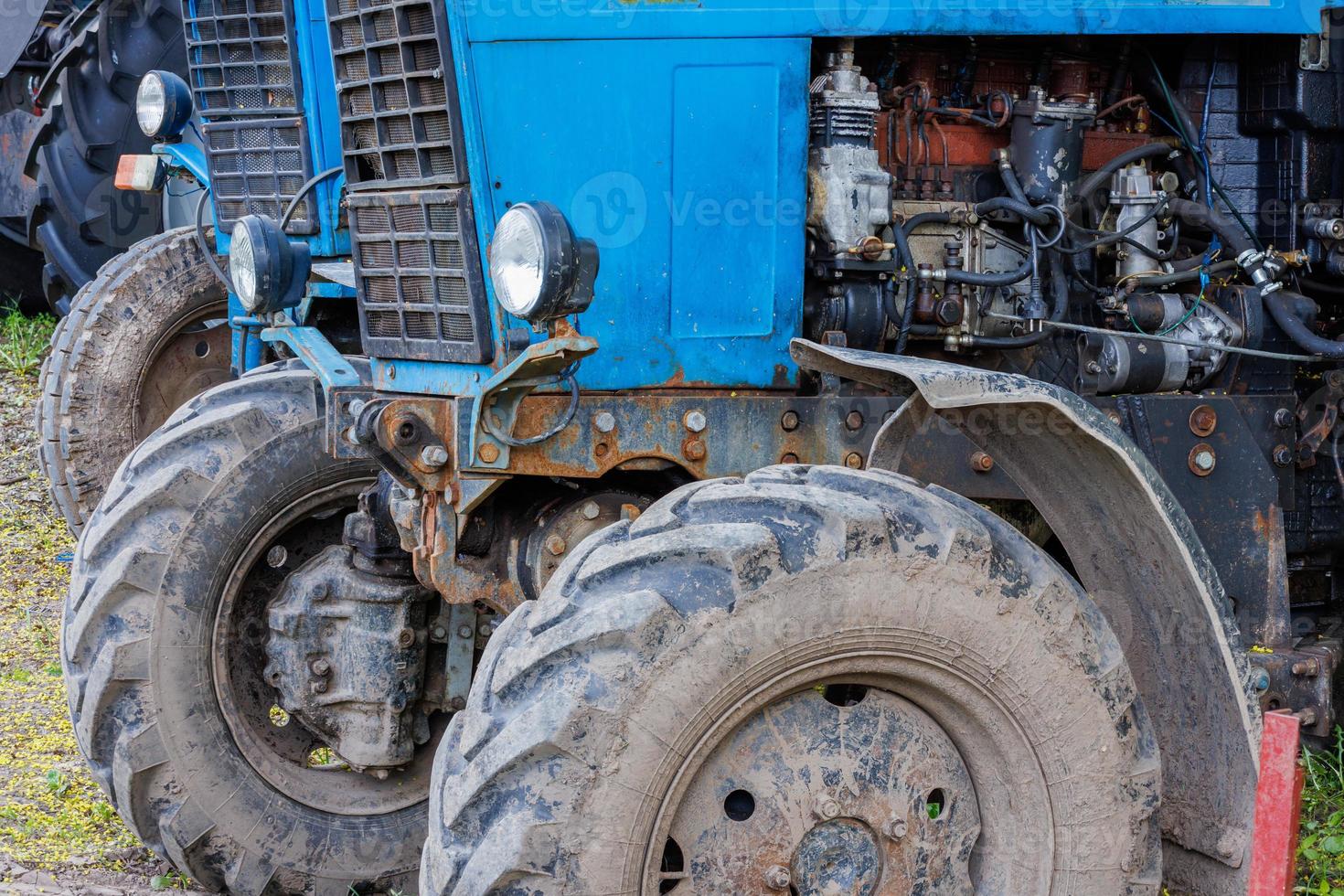 blue belarussian tractors, wheels and opened diesel engine compartments view photo