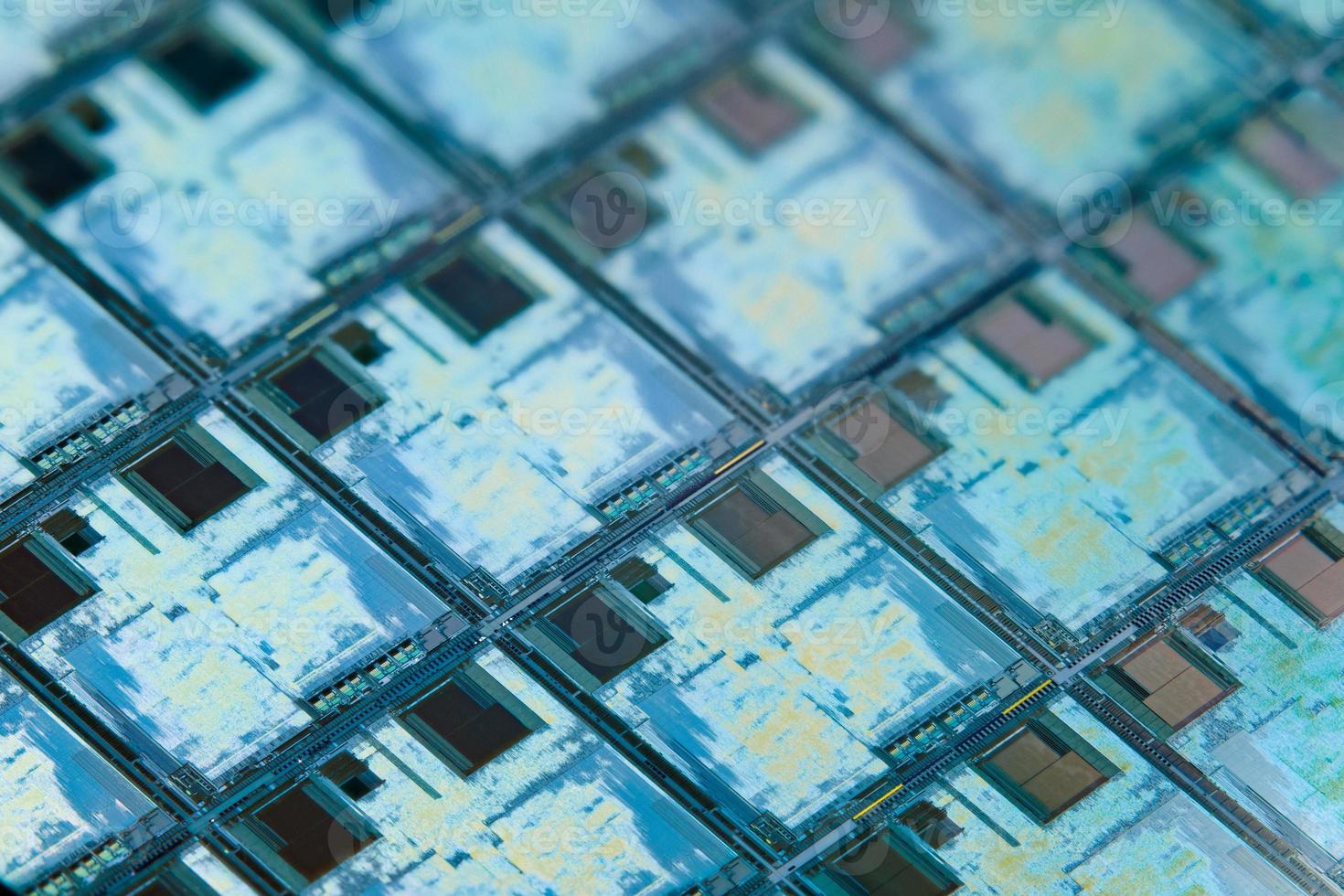 Silicon wafer with microchips used in electronics for the fabrication of integrated circuits. Full-frame high-tech macro background. photo