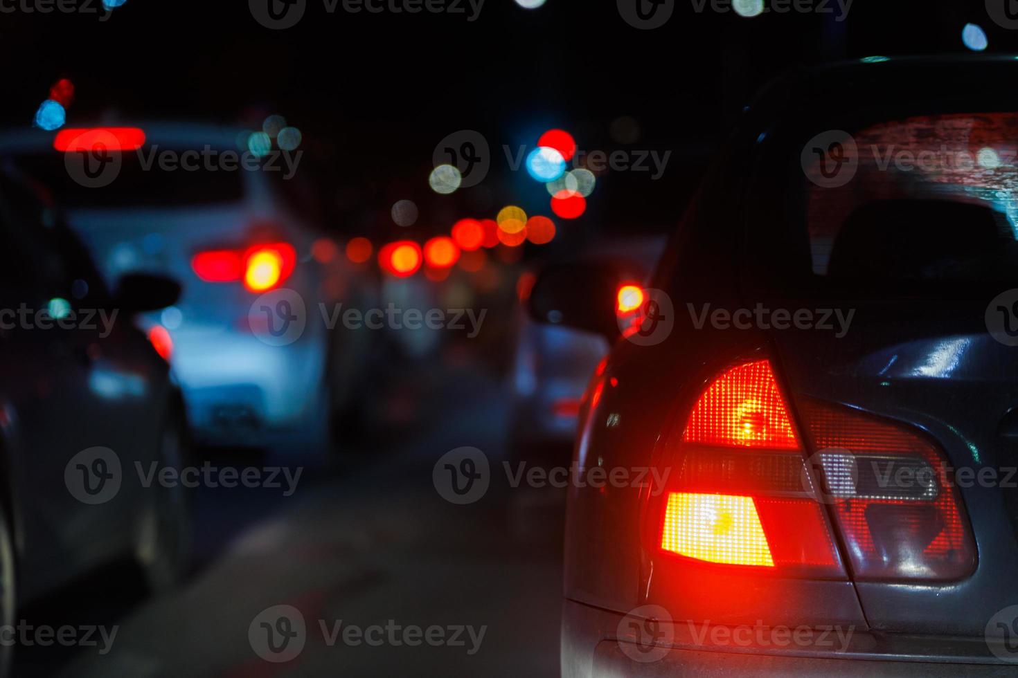 close-up view of car tail light and right turn signal at night traffic jam photo