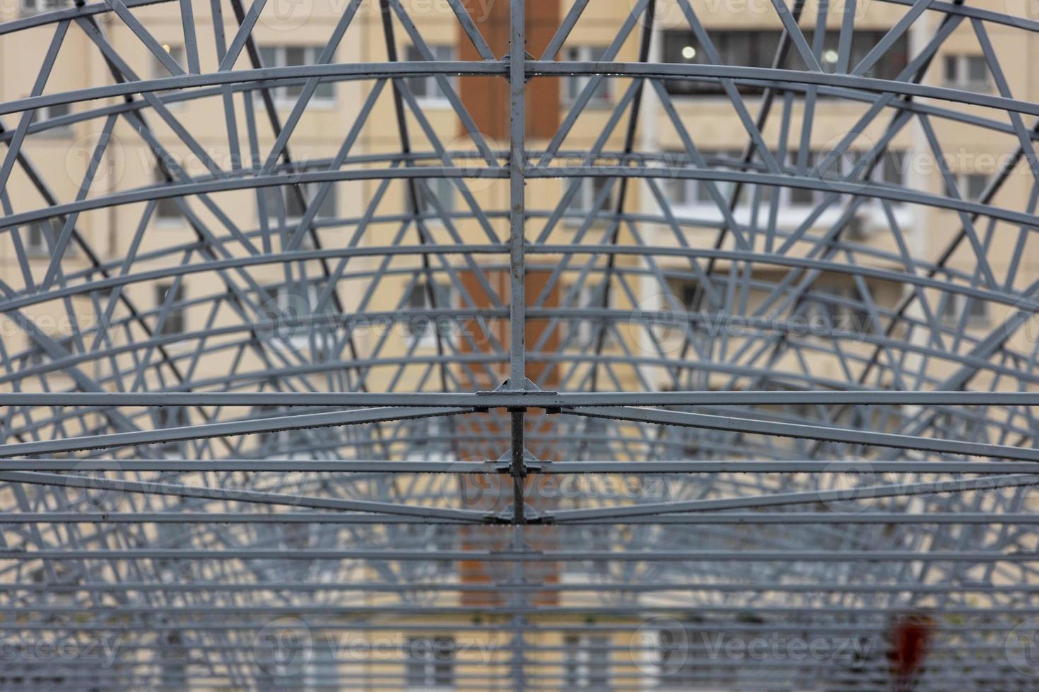 wet gray painted welded metal roof supporting truss, large steel structure photo