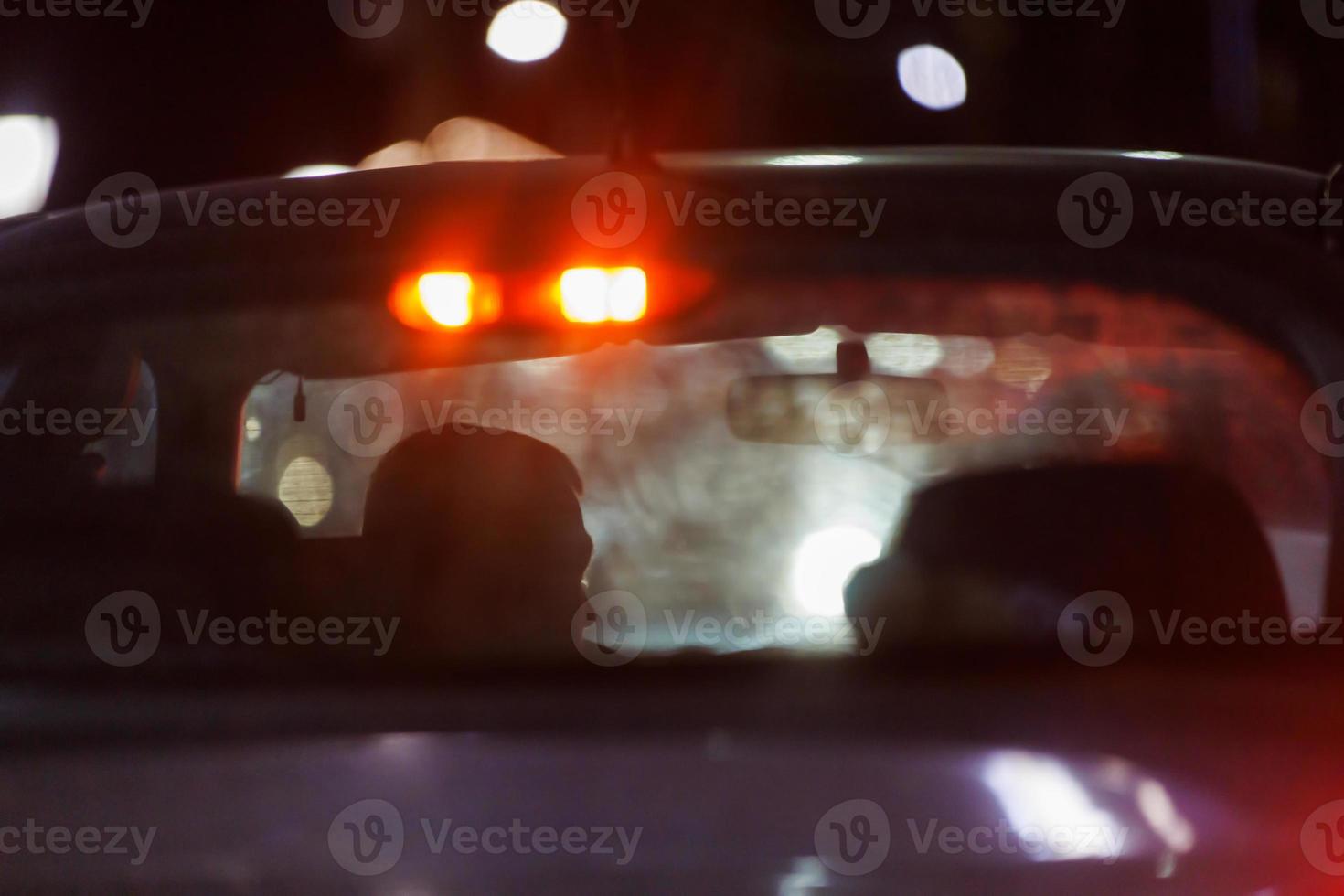 unrecognizable car driver in night traffic jam - view from behing outside photo