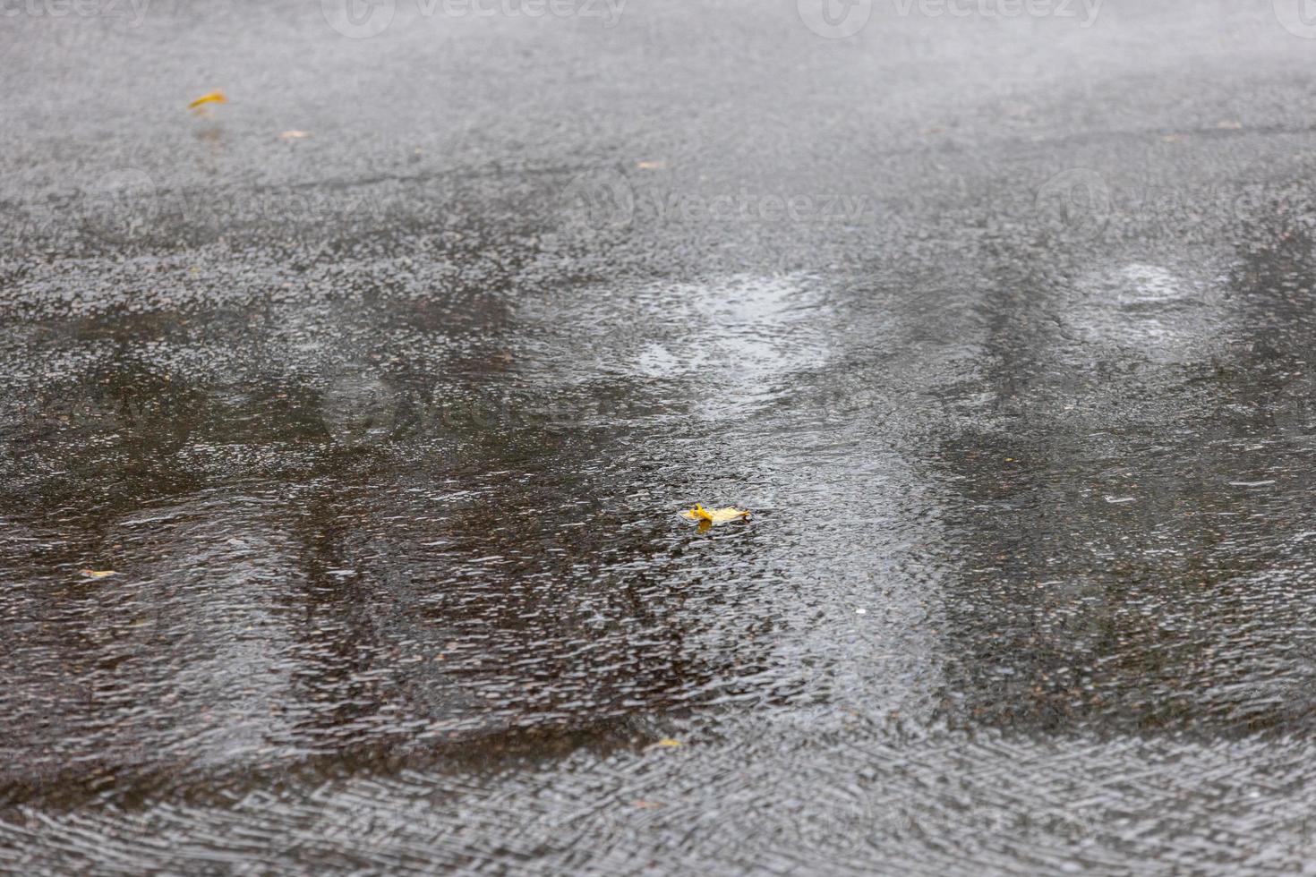 asphalt road under rainfall or drizzle with fast shutter speed photo