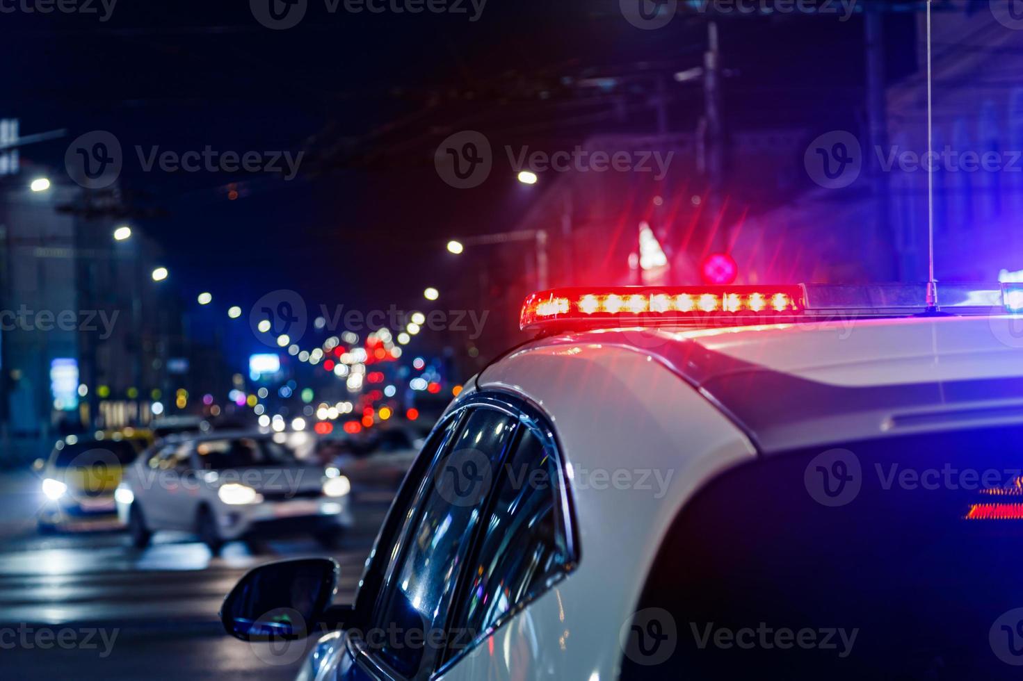 police car lights in night city with selective focus and bokeh photo