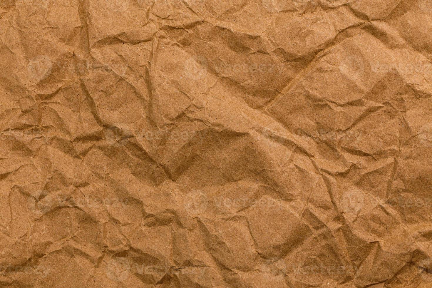 Ragged crumpled brown kraft paper texture and full frame background photo