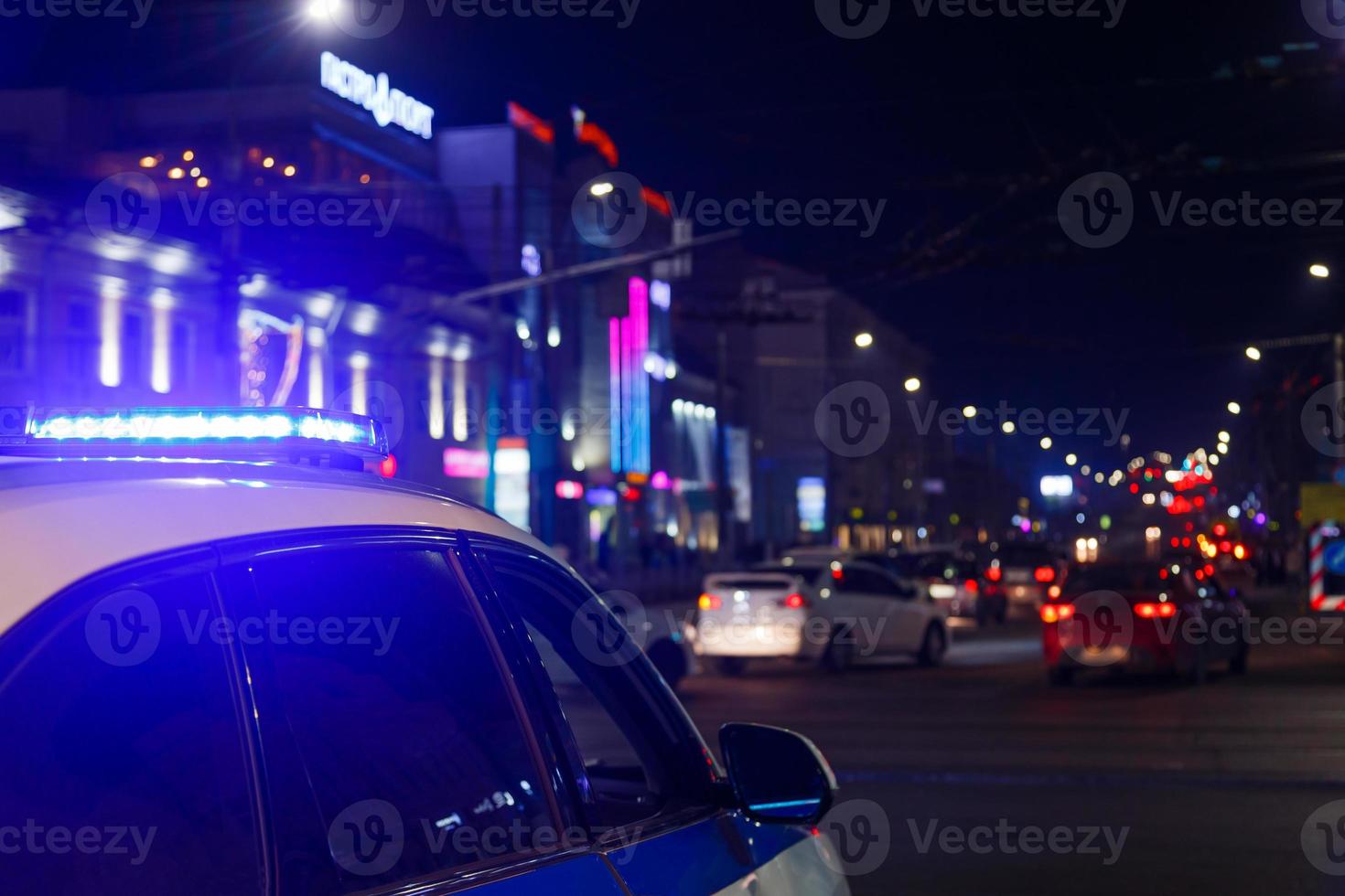 police car lights in night city with selective focus and bokeh photo