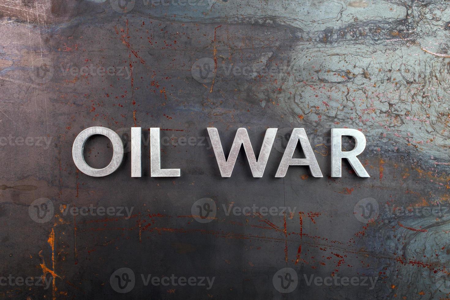 words oil war laid in line with silver metal letters on rusted heavy hot rolled uncoated steel sheet surface - directly above photo