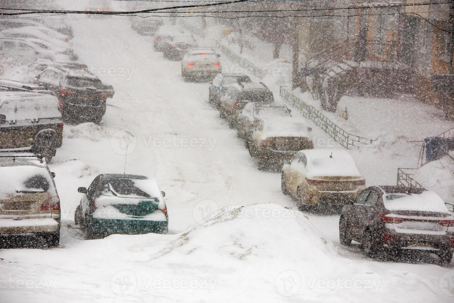 blizzard at parking near apartment building in winter russia photo