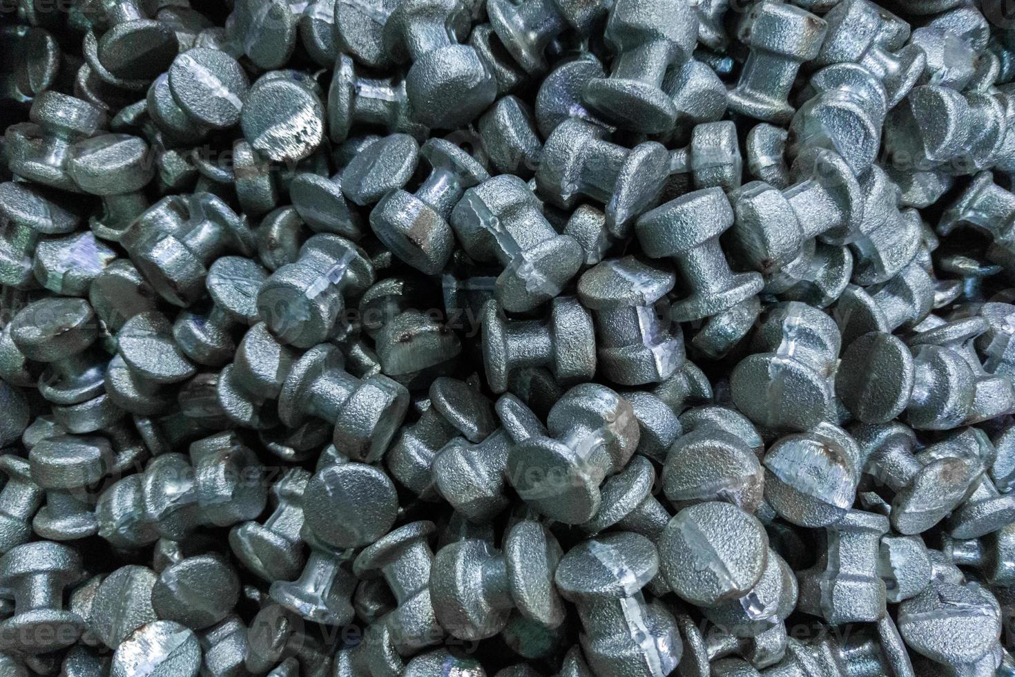 An abstract industrial full frame background of forged and sanded steel billets. Close-up with selective focus and blur. photo