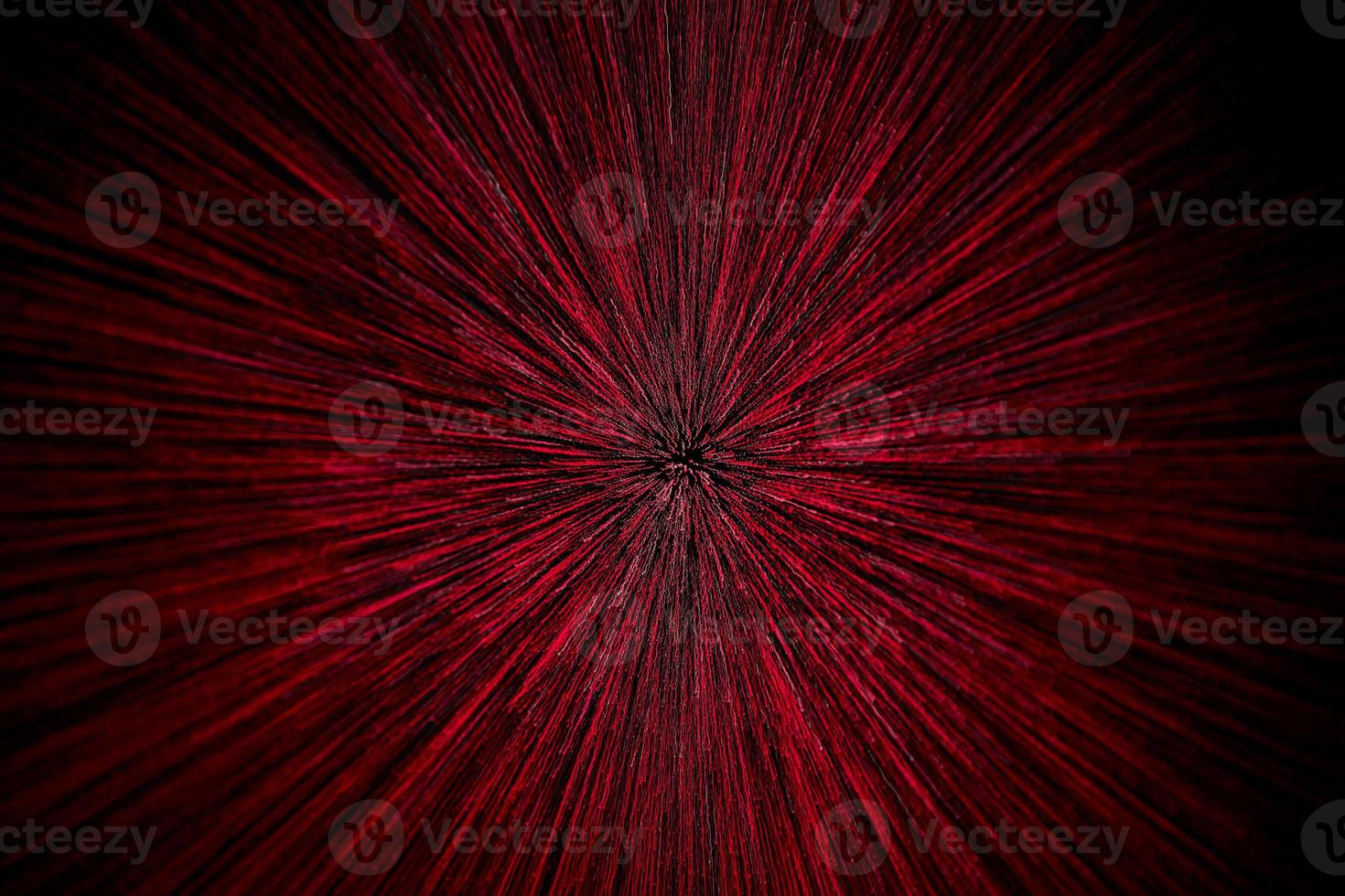 natural lens zoom explosion radial blurred red particles on black background with selective focus photo