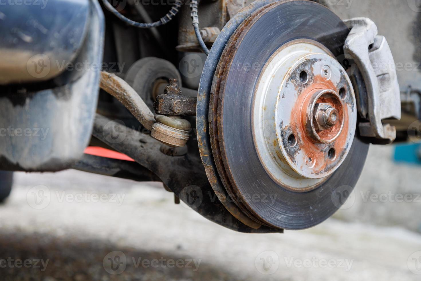 the hub of the front wheel of a jacked car during a tire change photo