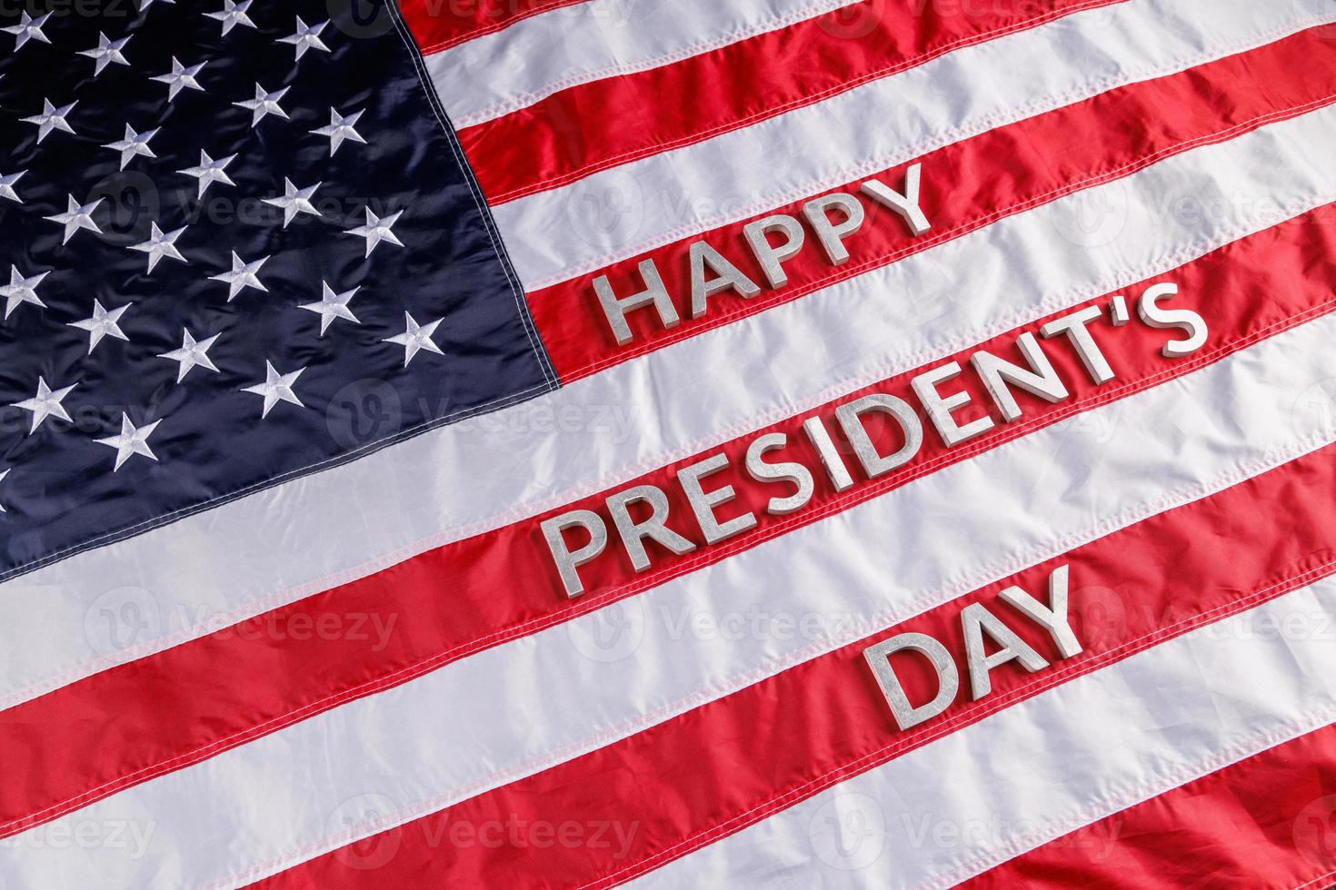 words happy presitdents day laid with real letters on US flag surface photo