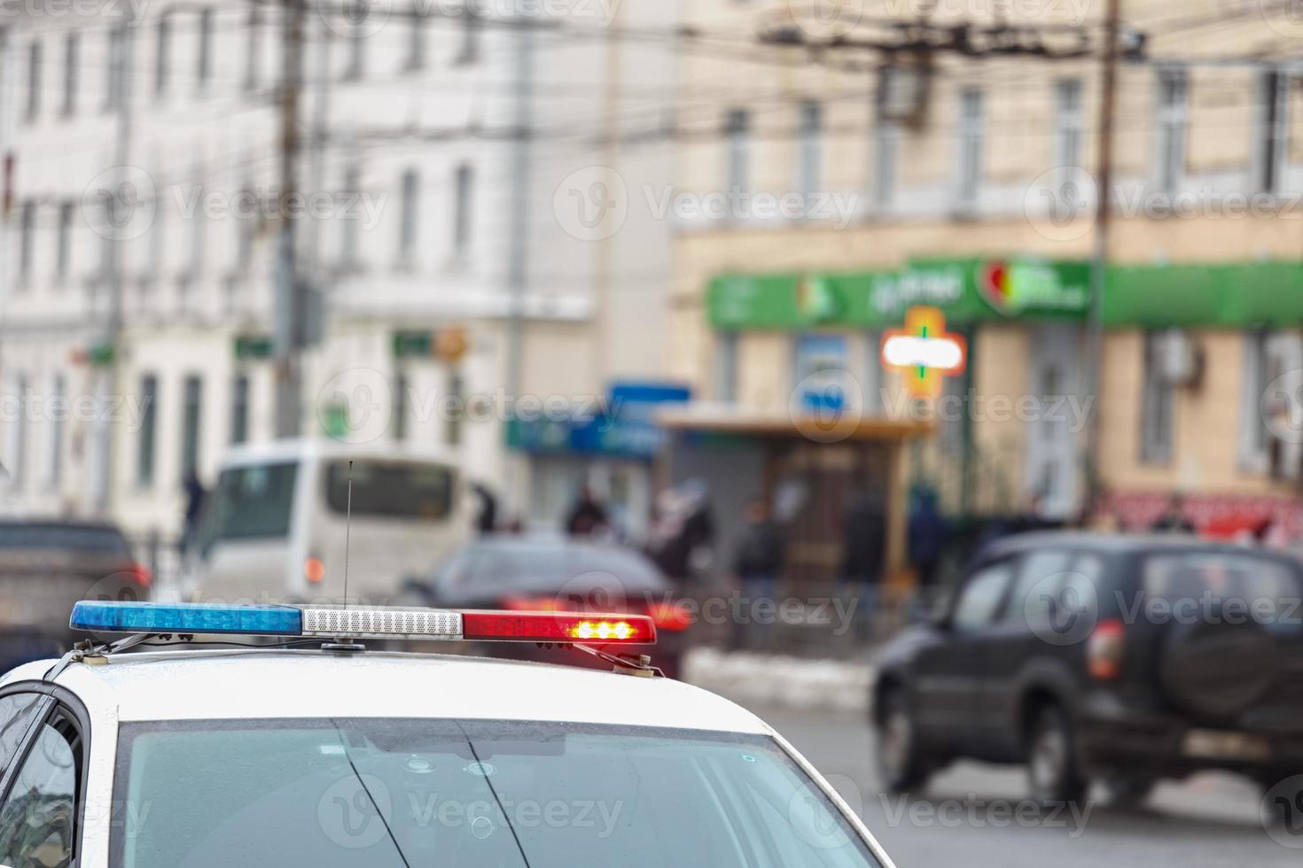 police car lights in city street with civilian cars traffic in blurry background in Tula, Russia photo