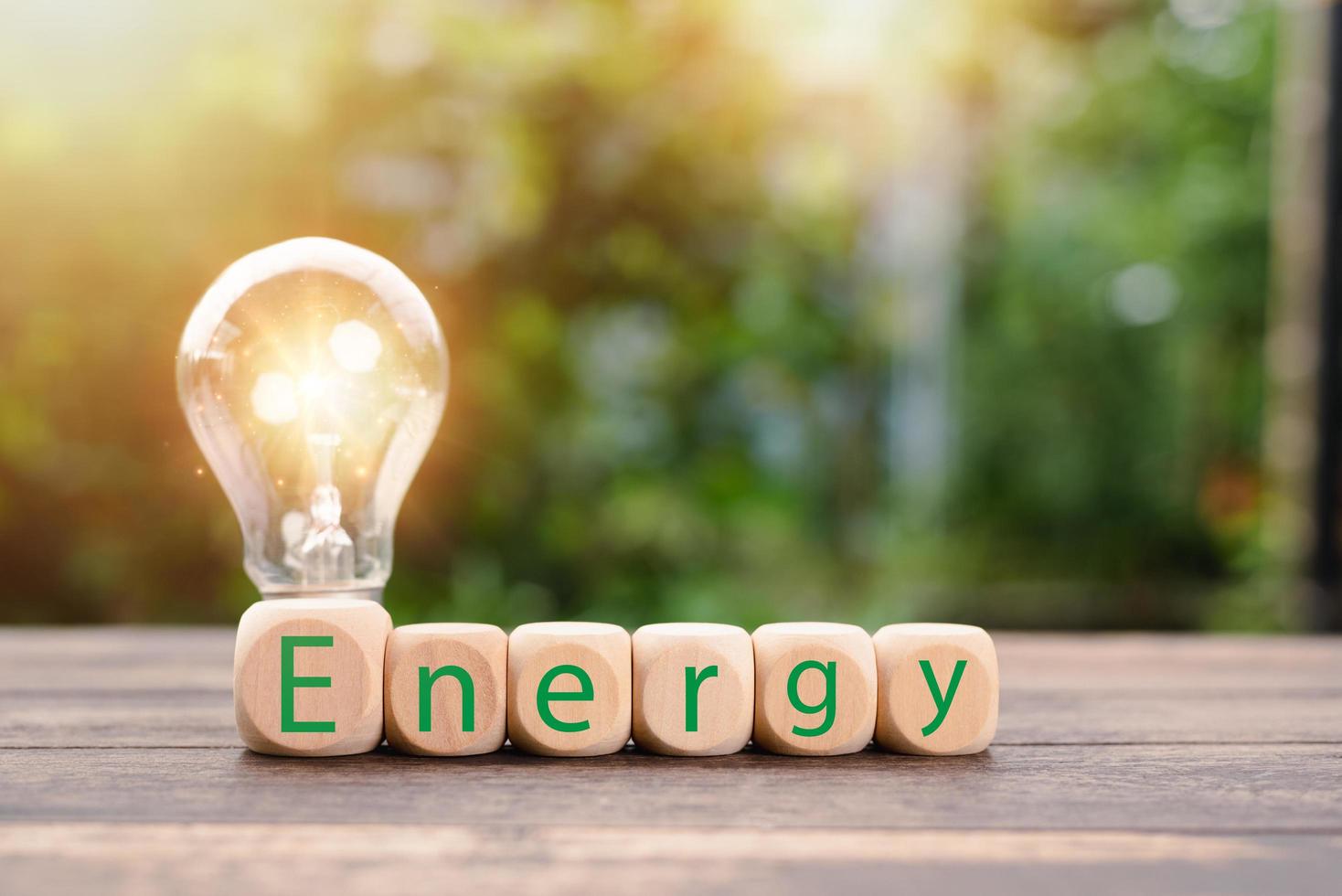 protecting the environment alternative energy Sustainable renewable energy sources Green energy innovation and environmentally friendly energy technology,wooden block is placed in front of the lamp photo