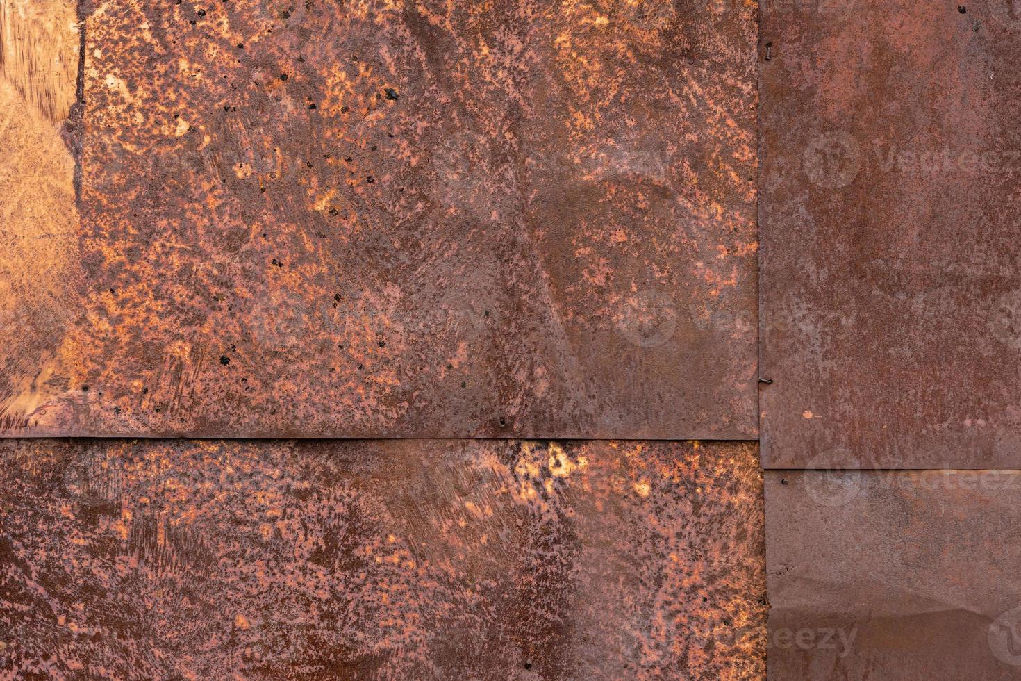 Rusted tin sheets patchwork wall texture and flat full frame background photo