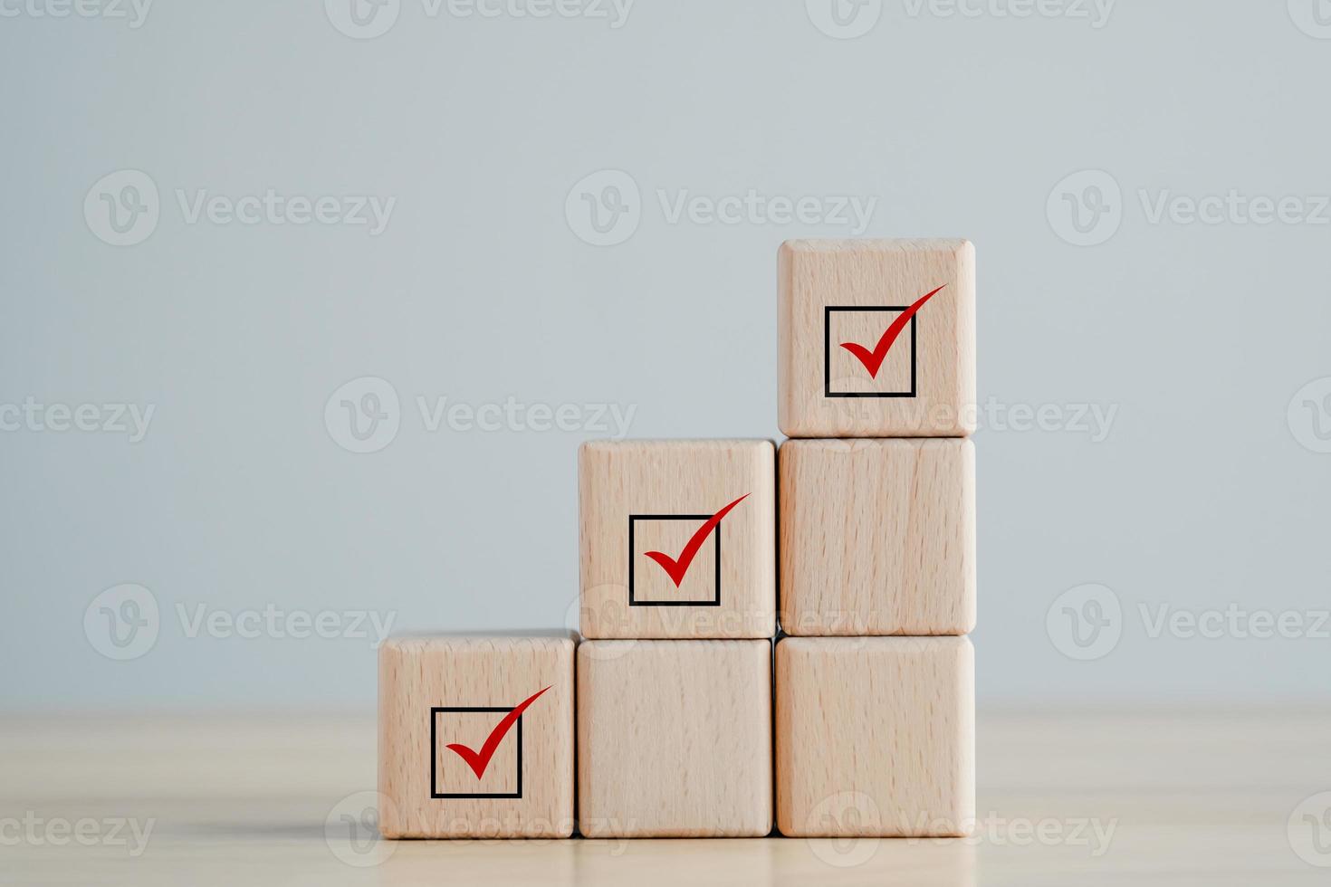 Checklist, Task list, Survey and assessment, Quality Control, Goals achievement and business success. Elections and Voting, Vote, to do list, Red check mark on stack of wooden block. photo