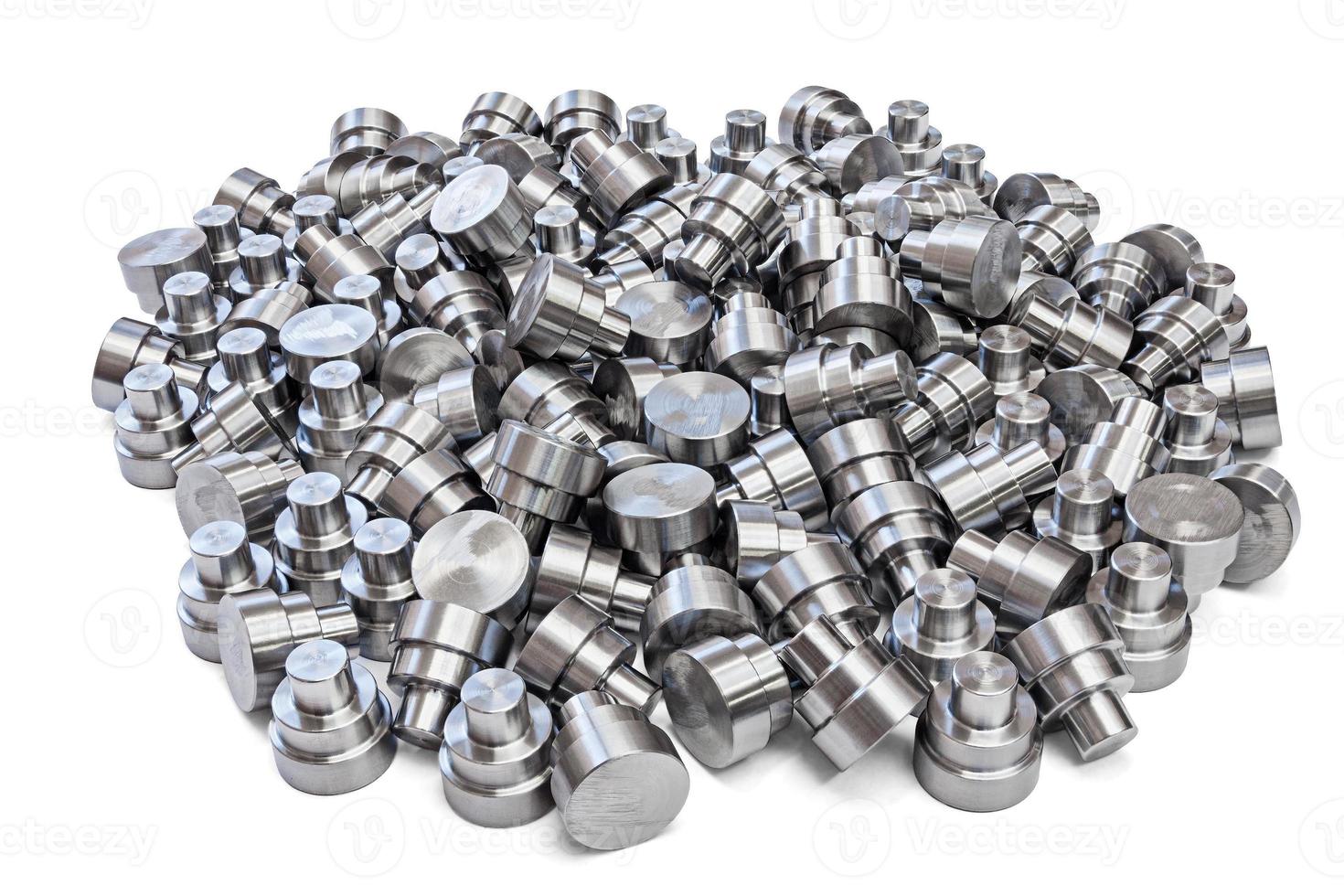 batch of shiny steel cnc turned parts isolated on white background photo