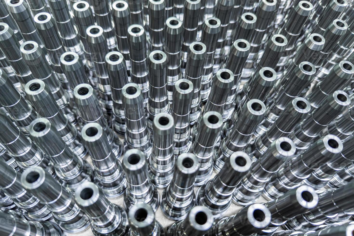 Shiny long steel parts full frame background, clean steel rods after fine cnc turning. photo