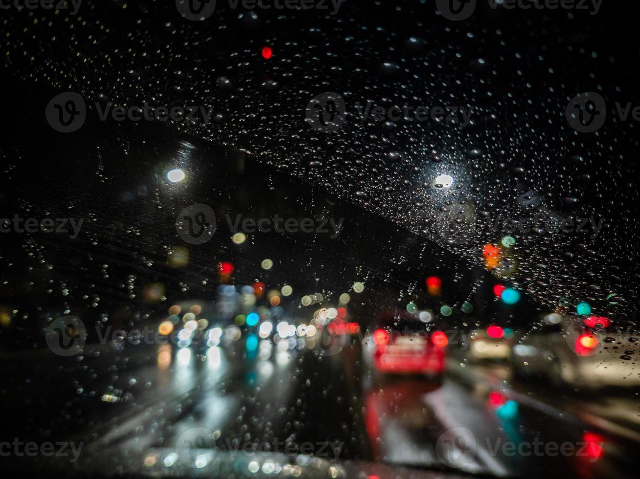 defocused photo of night driver view on city from right steering car