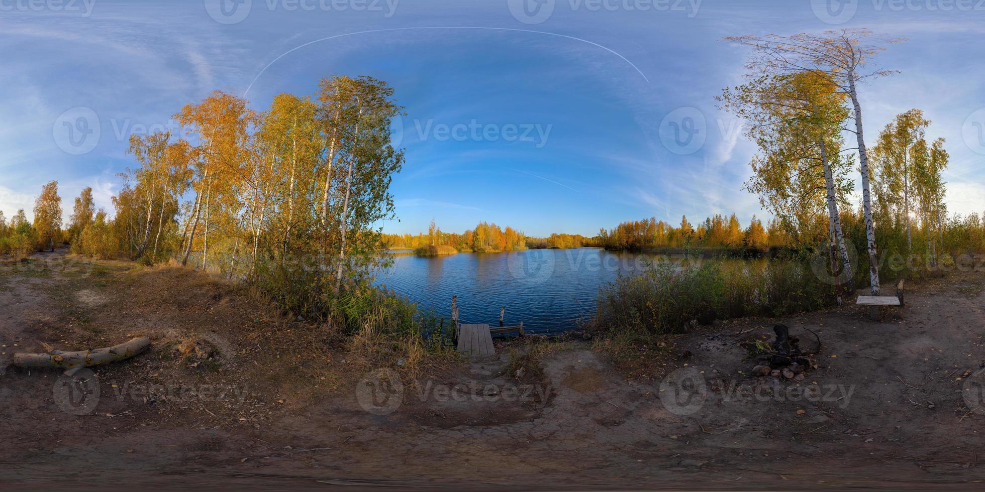 Full spherical 360 by 180 degrees panorama of evening autumnal lake with birch forest on its shores photo
