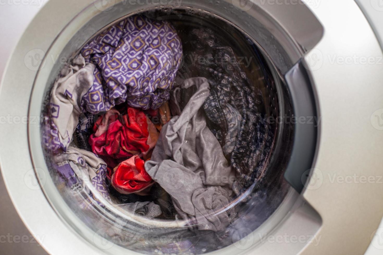 a close view of domestic washing machine at work photo