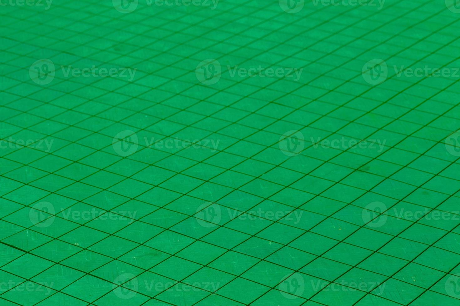 green plastic tiles on the floor of the outdoor playground photo