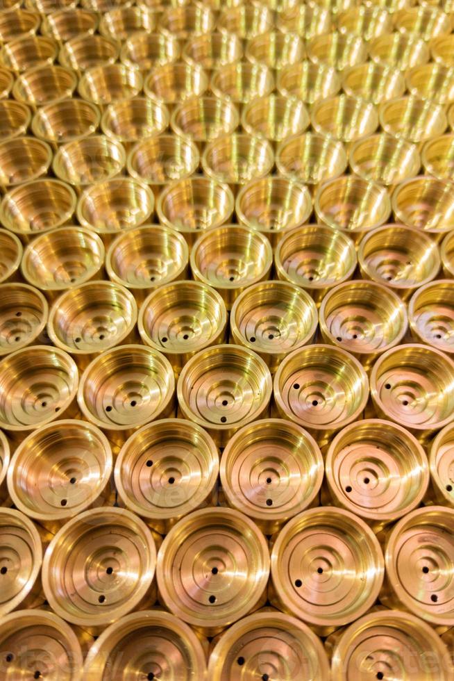 abstract industrial background of shiny brass metal threaded hexagonal parts photo