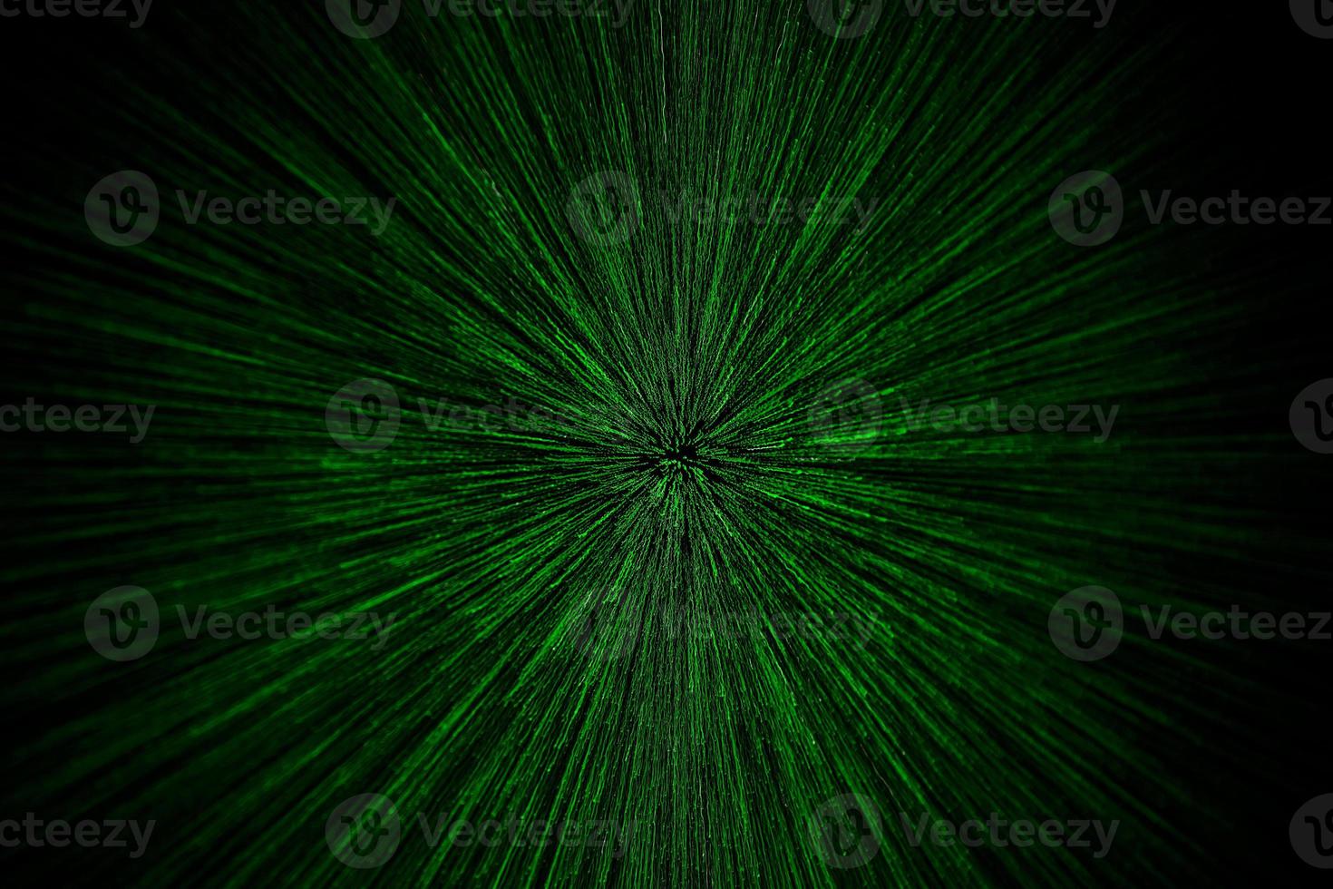 natural lens zoom explosion radial blurred green particles on black background with selective focus photo
