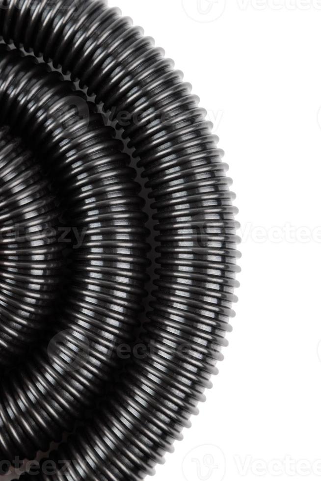 black plastic corrugated vacuum cleaner hose on white background photo