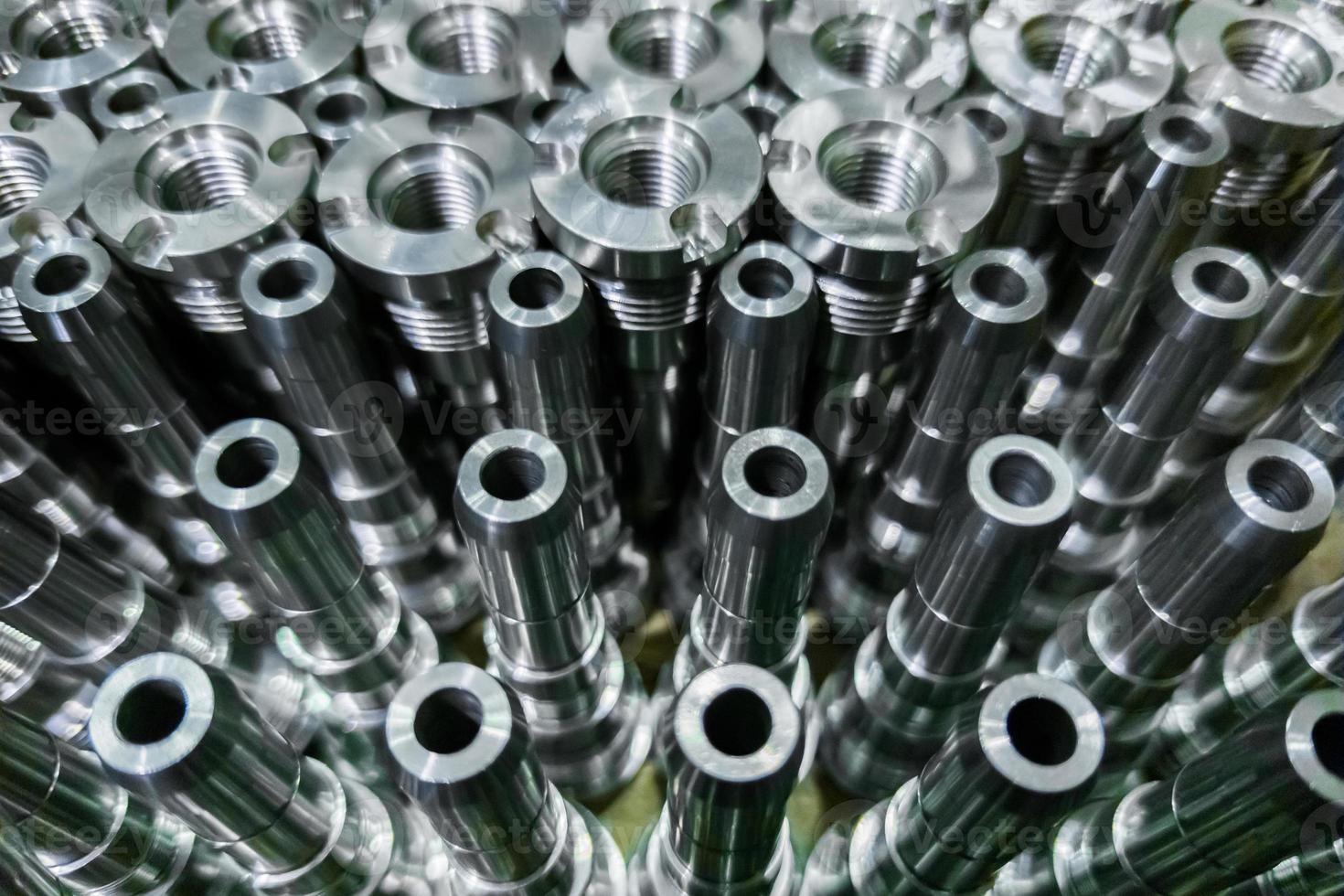 Shiny steel parts close-up background, long clean steel rods after fine cnc turning photo