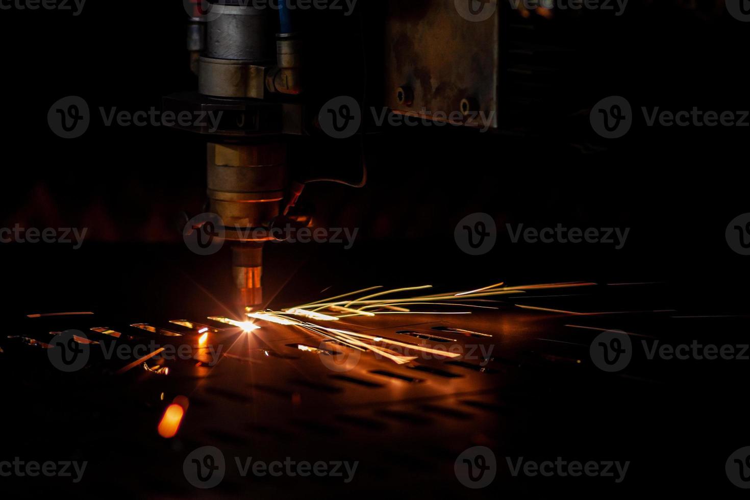 laser cutting process dark closeup with selective focus and sparks photo