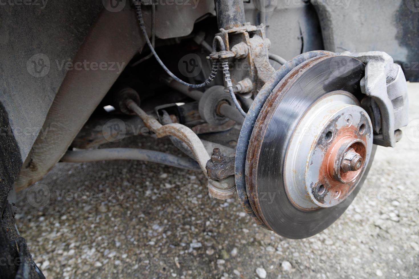 the hub of the front wheel of a jacked car during a tire change photo