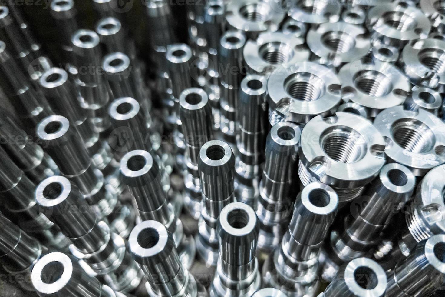 Shiny steel parts close-up background, long clean steel rods after fine cnc turning photo