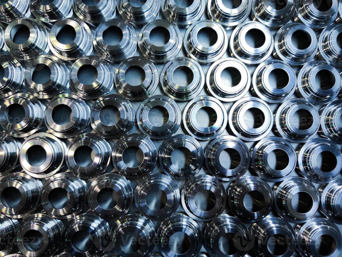 a batch of shiny metal cnc aerospace parts production - close-up flat lay with selective focus for industrial background photo