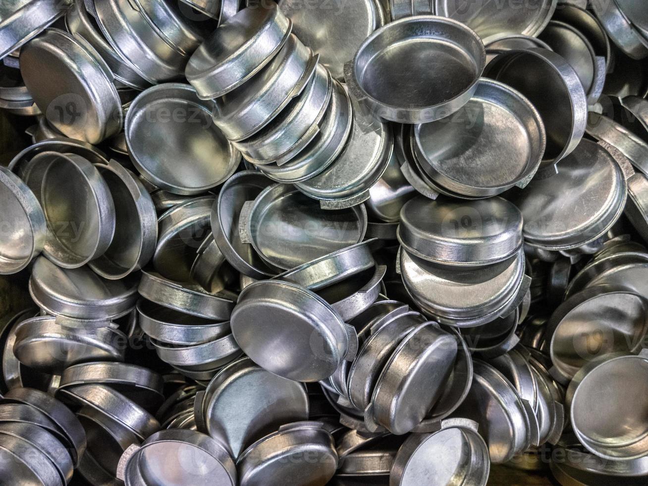 batch of olod stamped shiny metal caps, selective focus top-down wiew photo