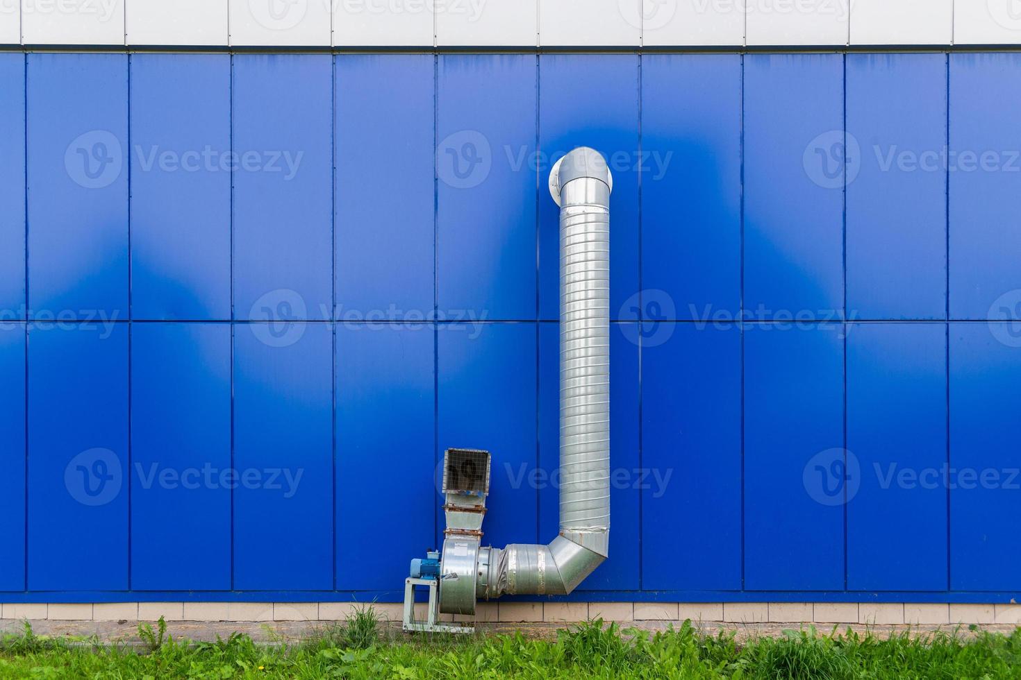 industrial grade air extraction duct with electrical motor on blue wall photo