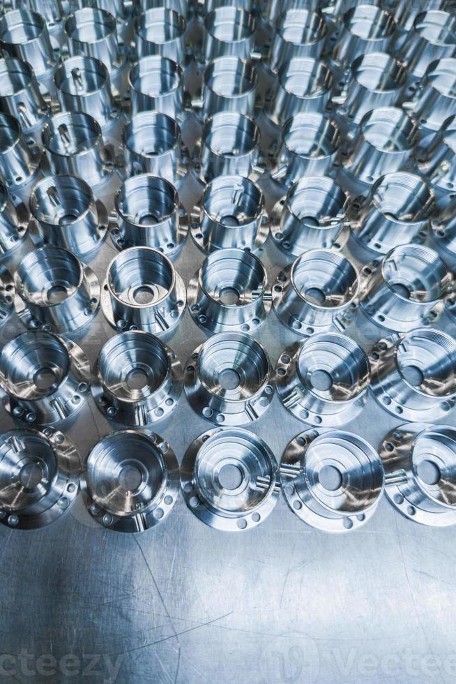 a batch of shiny metal cnc aerospace parts production - close-up with selective focus for industrial background photo