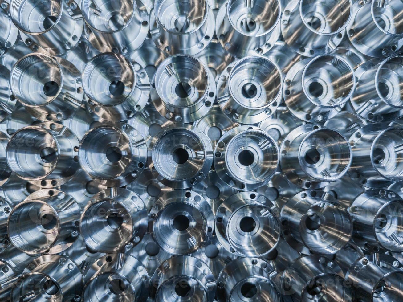 a batch of shiny metal cnc aerospace parts production - close-up flat lay with selective focus for industrial background photo